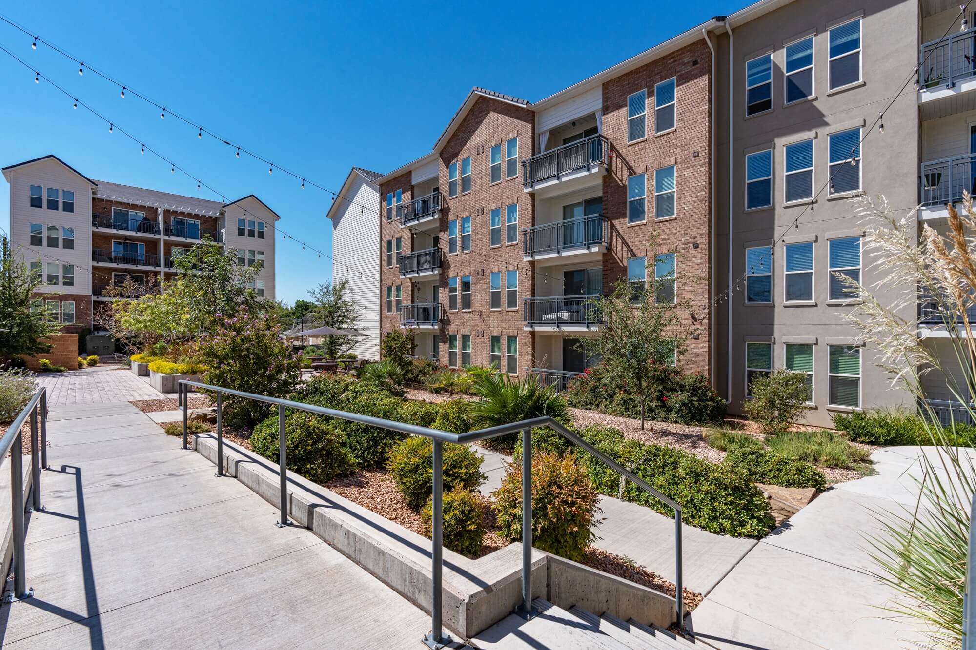steps leading up to an apartment building with stairs and landscaping