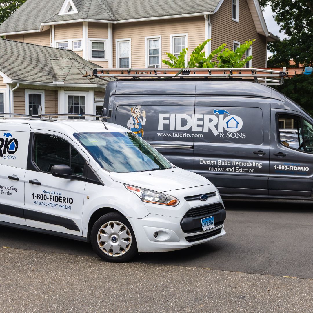 Fiderio vans positioned in front of the Meriden office, showcasing both the family-friendly mascot and professional vehicle wraps.