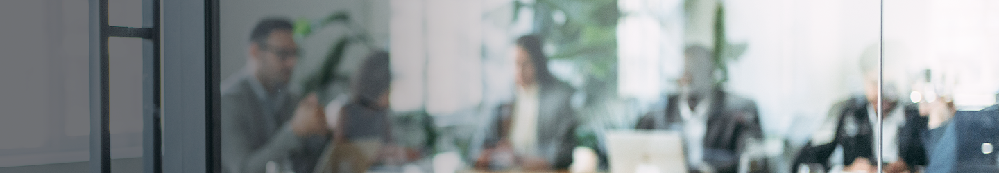 Professionals working around a boardroom table.