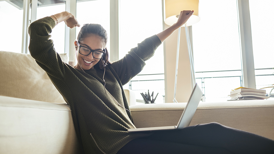 A woman sitting down and celebrating