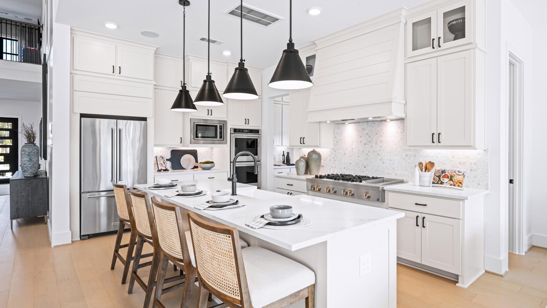 Chef-inspired kitchen with pendant lighting, premium stainless steel appliances and ample cabinet space