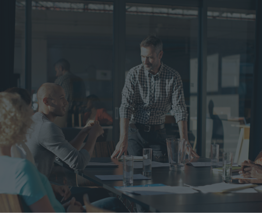 A group of professionals collaborating around a boardroom table.