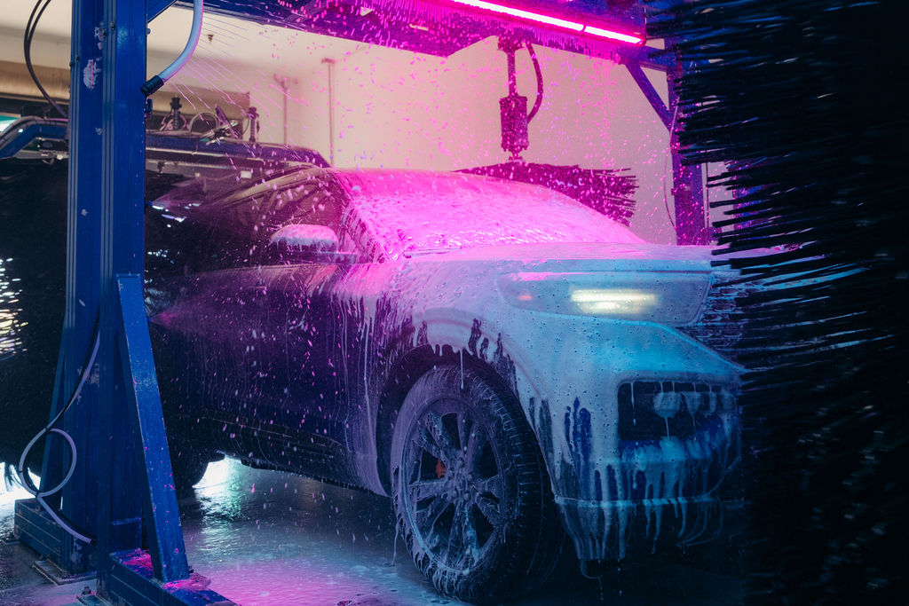 Vehicle receiving a premium foam wash inside the DASH Car Wash tunnel. 