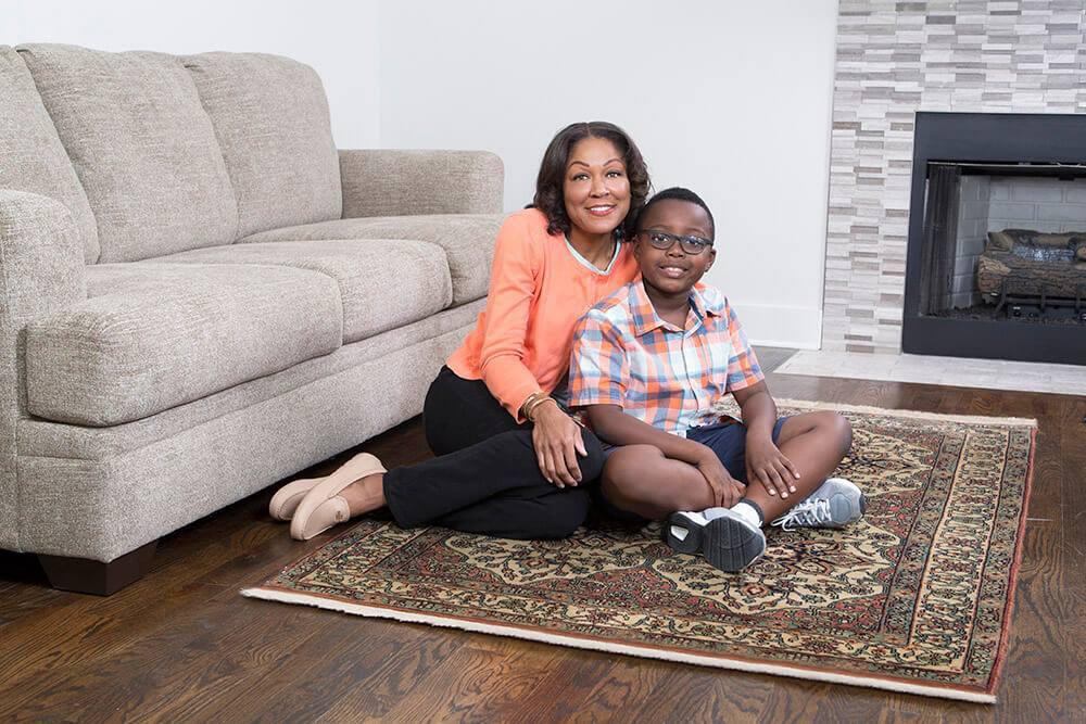 Family sitting on clean area rug in Chesapeake home