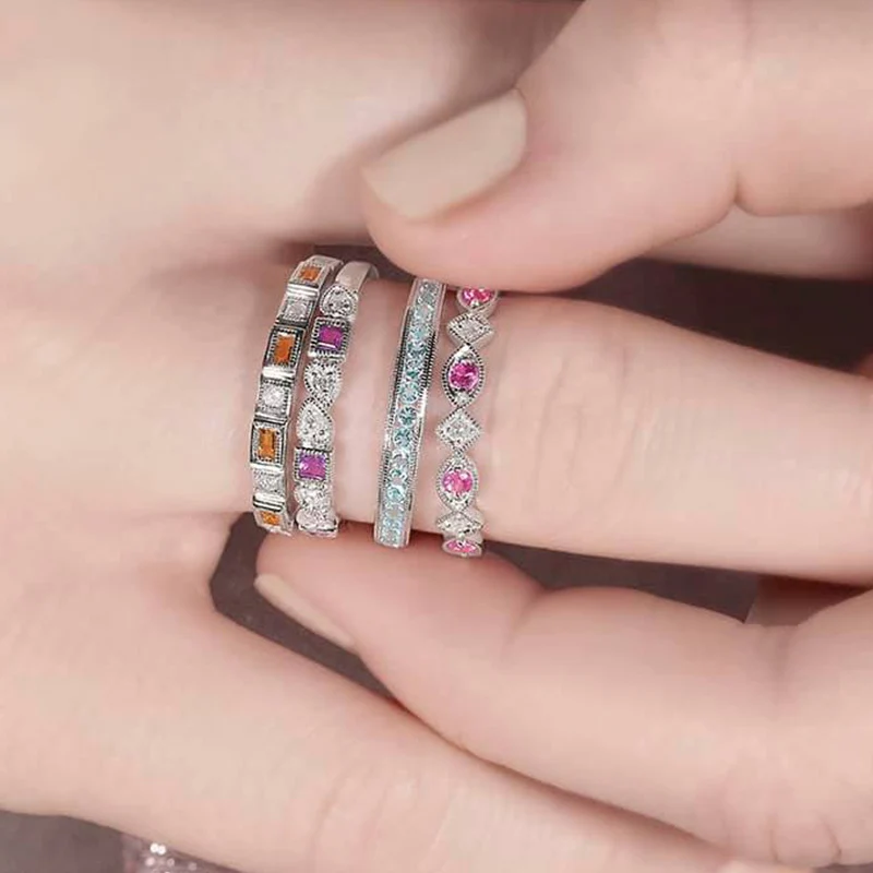Elegant white gold stackable diamond and gemstone bands featuring vibrant pink, orange, and blue gemstones. Perfect for stacking, anniversary gifts, everyday wear, or adding colorful sparkle.