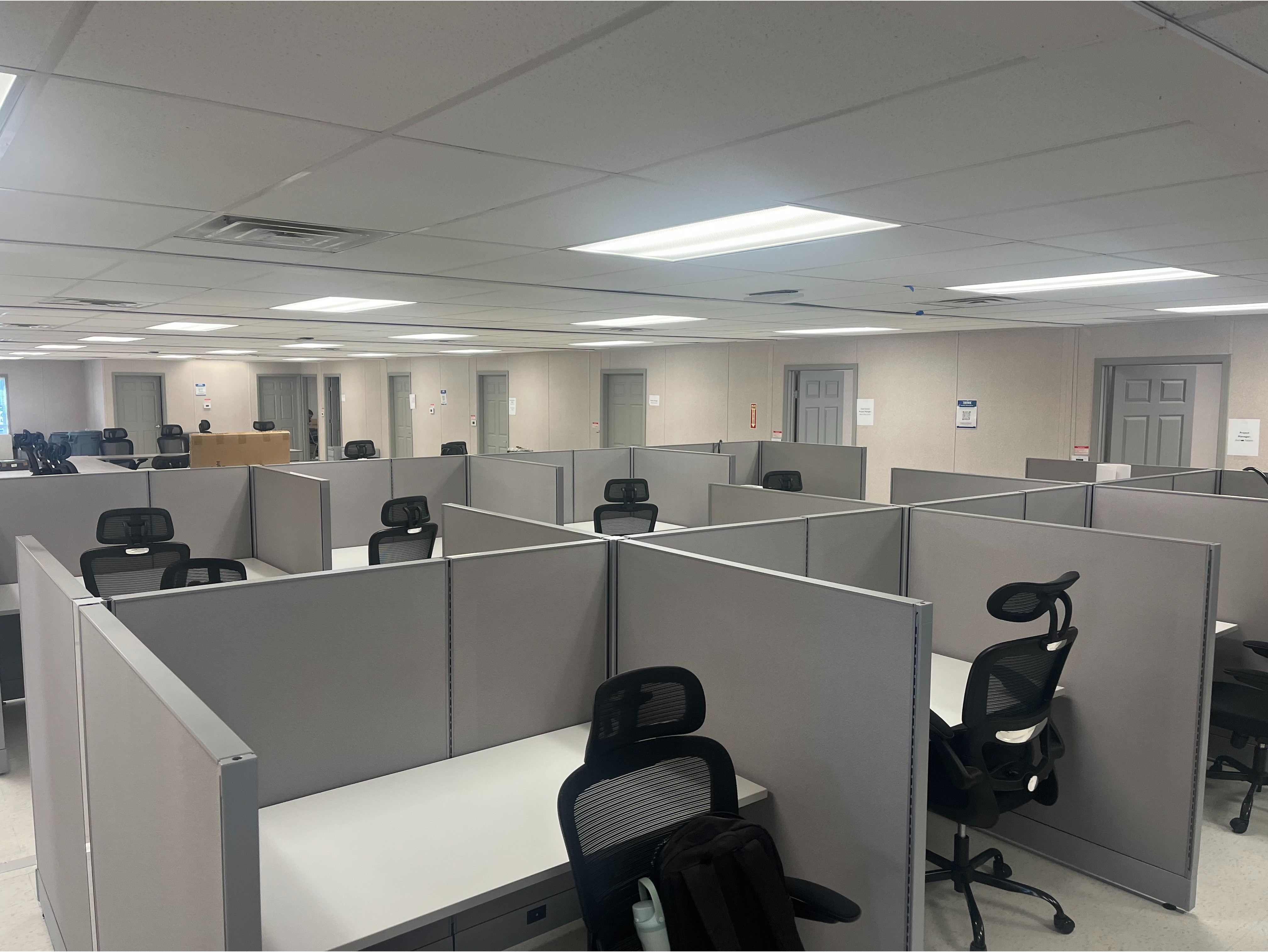 Private Manager's Cubicle:

High-wall privacy cubicle with a sliding glass door unit, full overhead storage cabinets, and lateral file drawers.