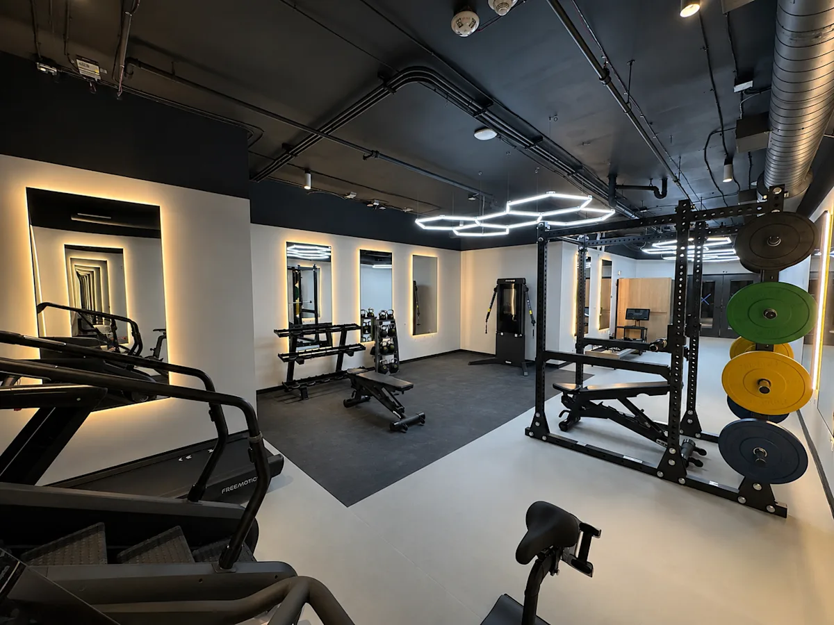A gym with treadmills, weights and exercise equipment