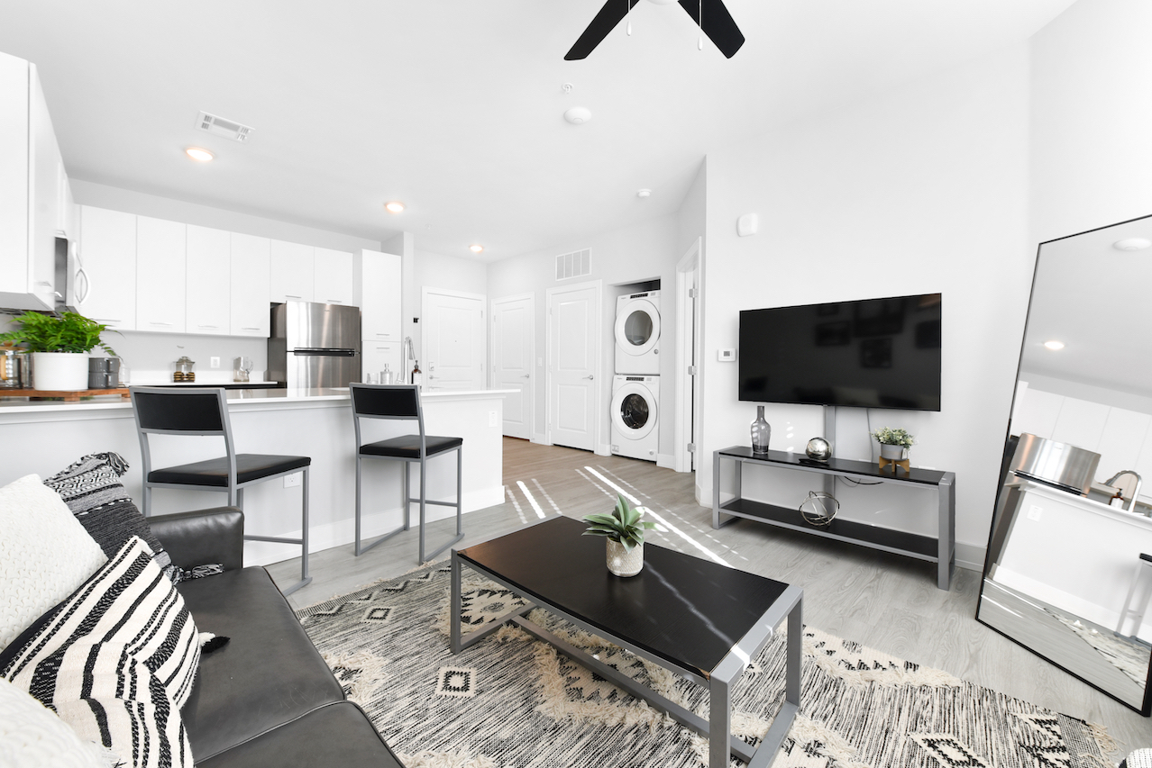 Fully furnished, spacious living room with smart tv.