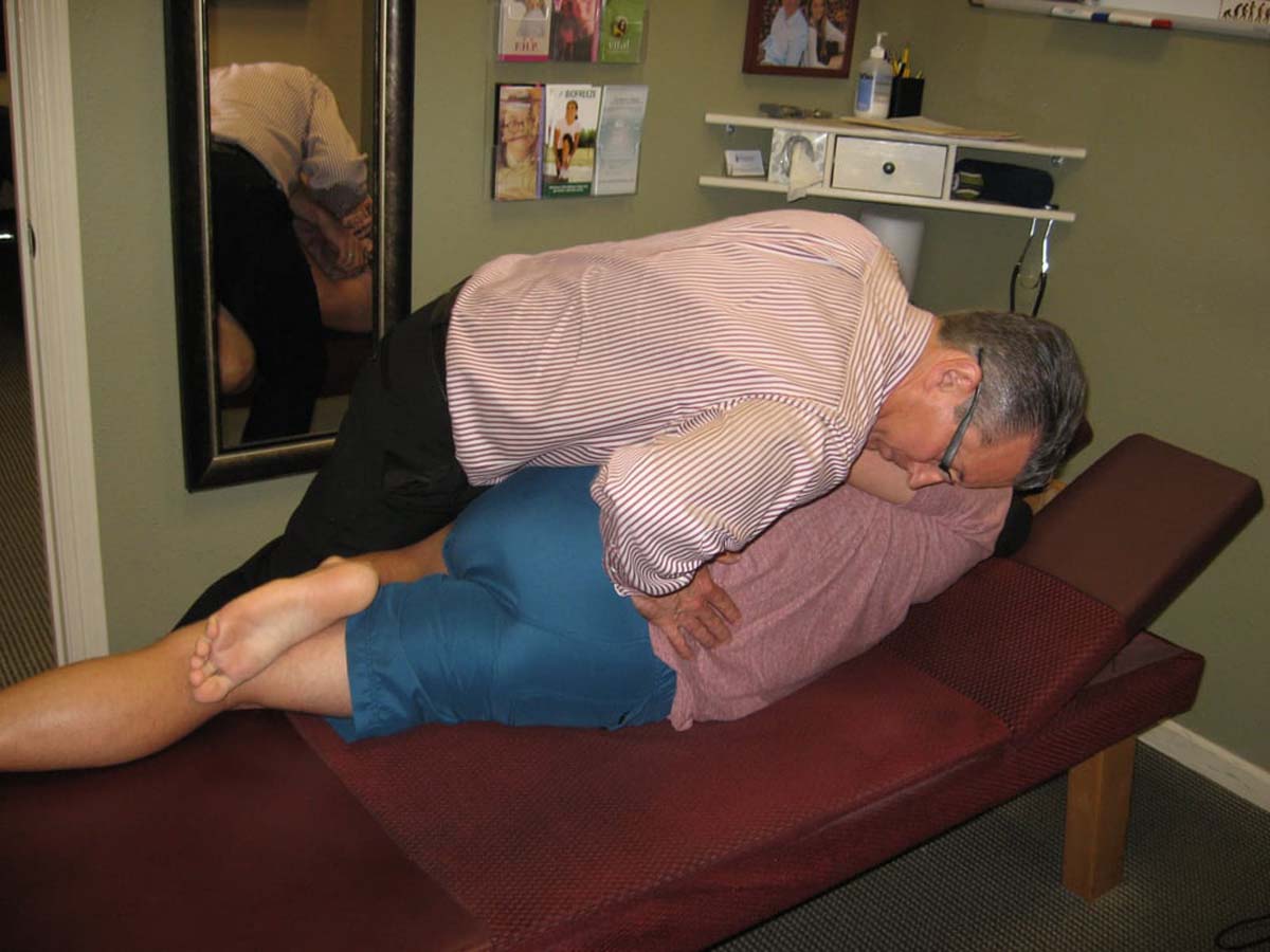 Dr. Pontious performing a spinal adjustment.