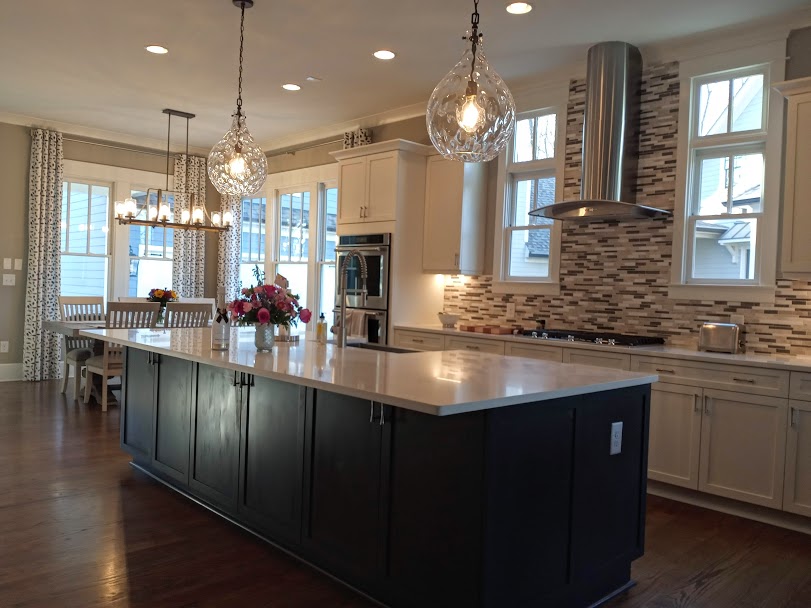 Check out the newly finished kitchen of our client. She has a great mix of modern and rustic elements melded together to create a beautiful and open space, perfect for serving up delicious meals and entertaining. What do you think of that sleek range hood? And those light fixtures!