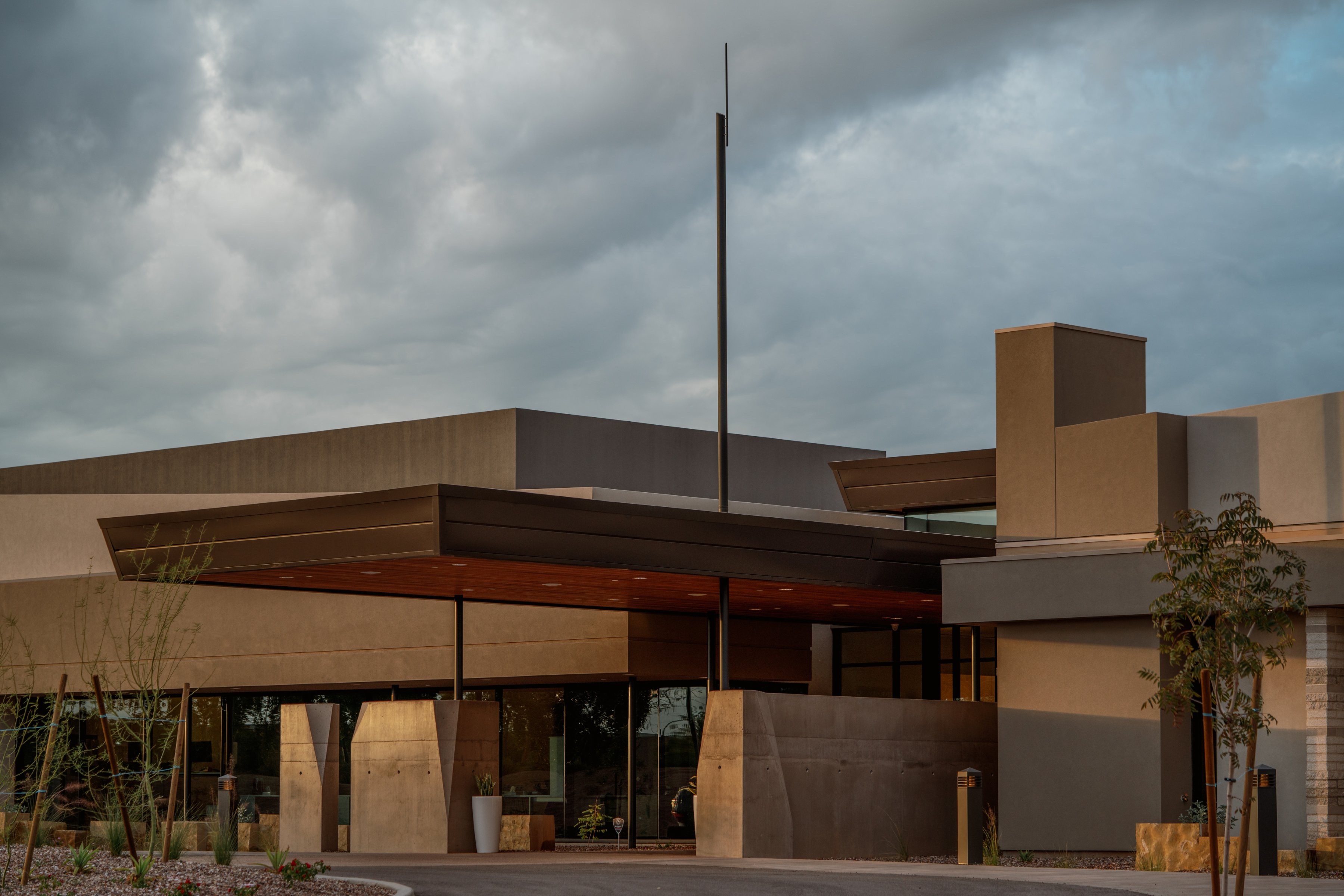 Stone, wood and desert plantings on the exterior of the Gilbert Memorial Park building.