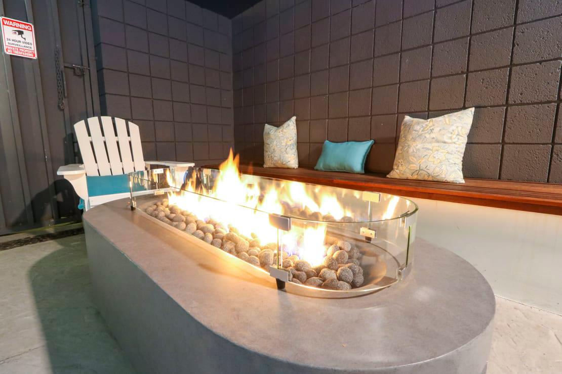 Pool side fire pit table at Westwood Riviera Apartments