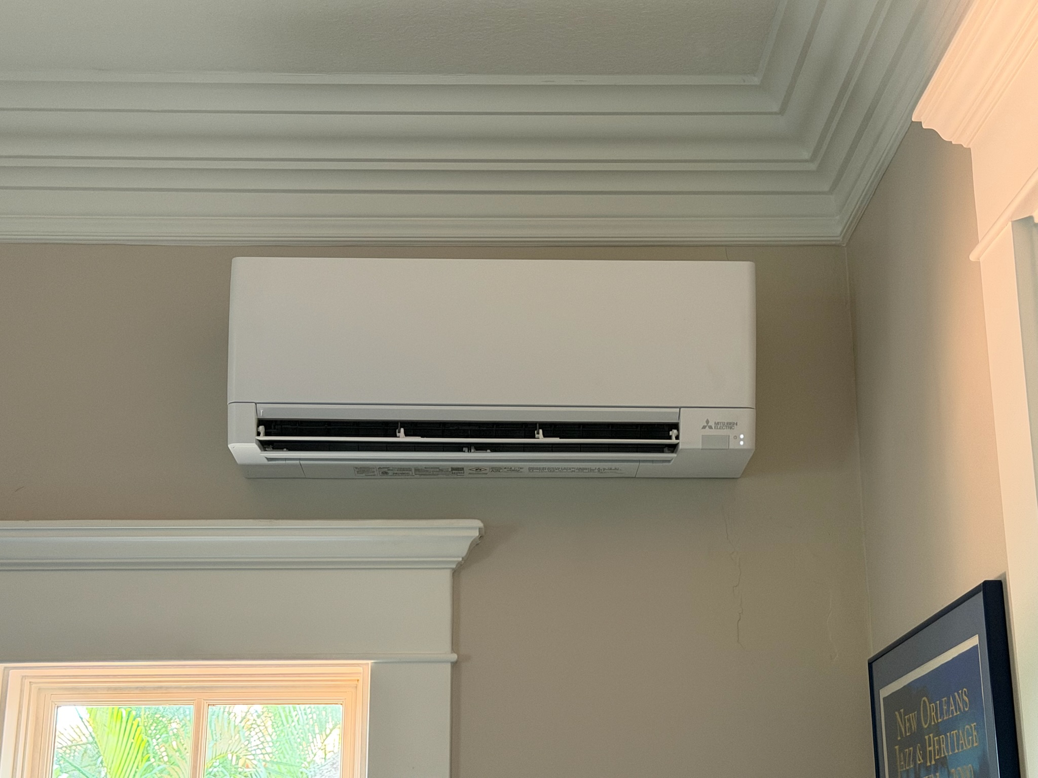 Wall-mounted ductless mini-split air conditioner providing targeted heating and cooling for an inter 