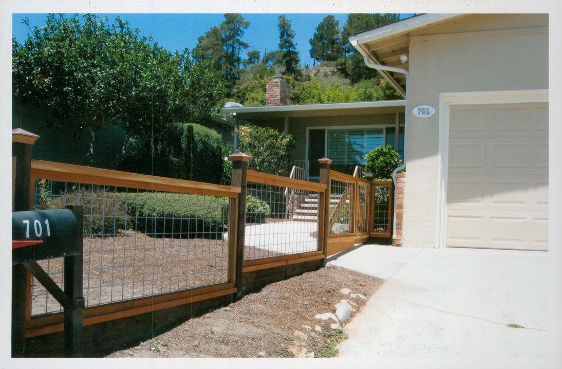 Wood fence and driveway gate installation adding secure access and curb appeal to a residential property.