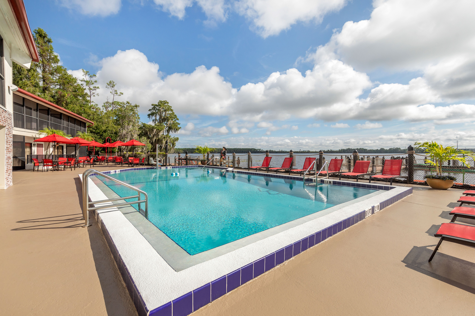 The outdoor pool with seating and lake view at Bryan's Spanish Cove.