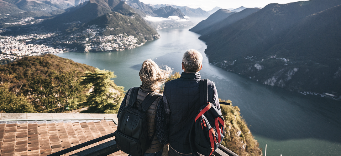 A couple looking out at a mountain valley.