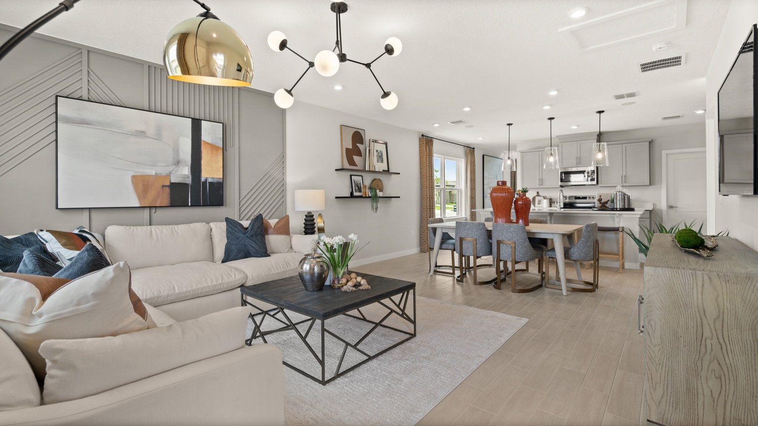 The Jupiter Model Home Open Concept Living Area at Grasslands West by DRB Homes