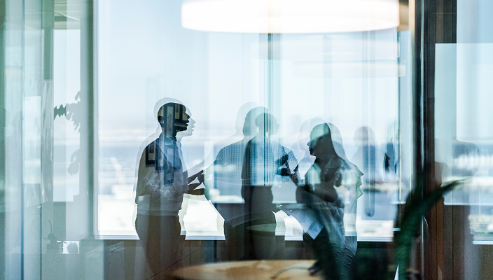 Three people working in an office.