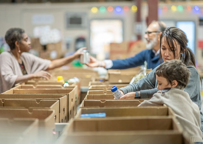 People volunteering at a food drive.