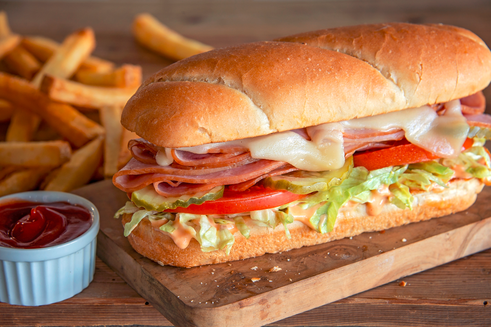 Grilled smokehouse ham served on a toasted hoagie with melted Swiss cheese, tomatoes, lettuce, pickl