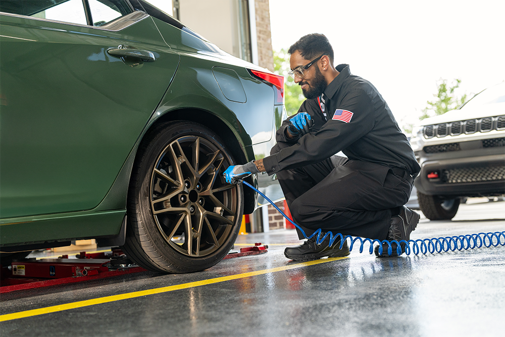 Valvoline technician inflates customer tire as part of our 18 point maintenance check.