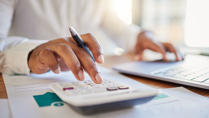 Close-up shot of a person using a calculator.