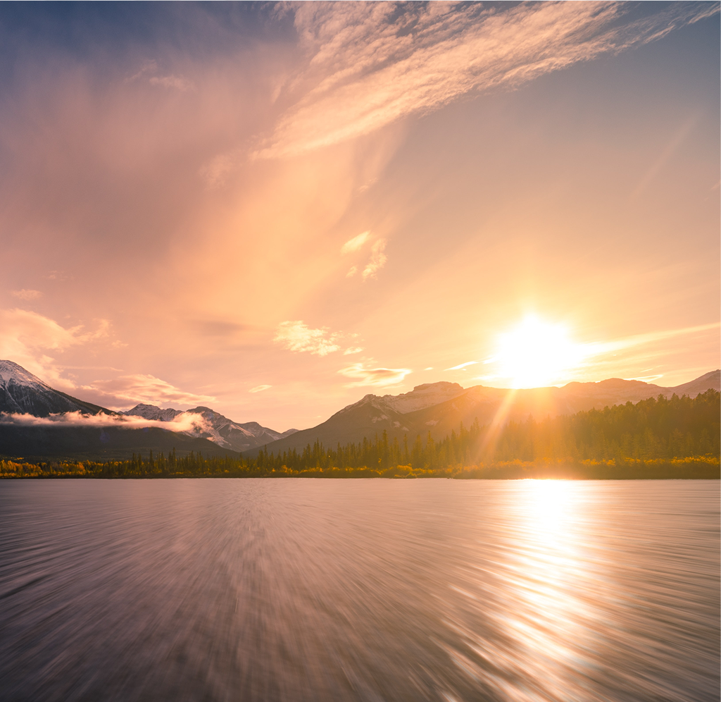 The sun rising over a stunning mountain landscape.