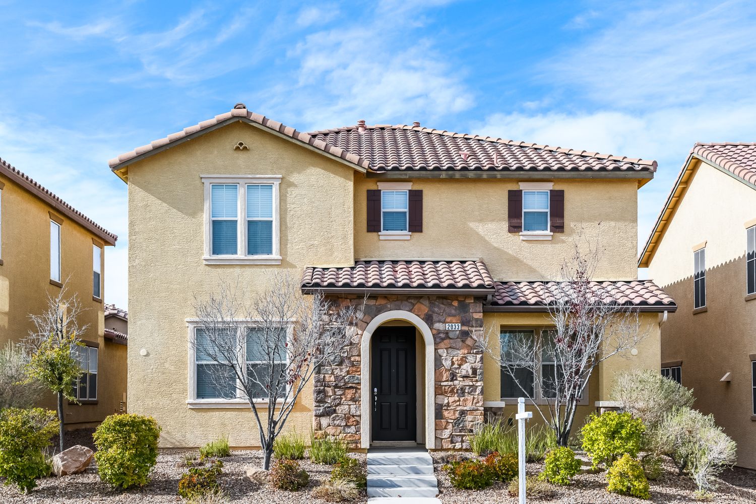 Front of home with a covered porch and stairs leading up at Invitation Homes Las Vegas.