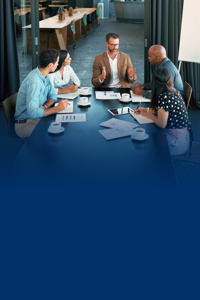Group of professionals having a lively conversation in a boardroom.