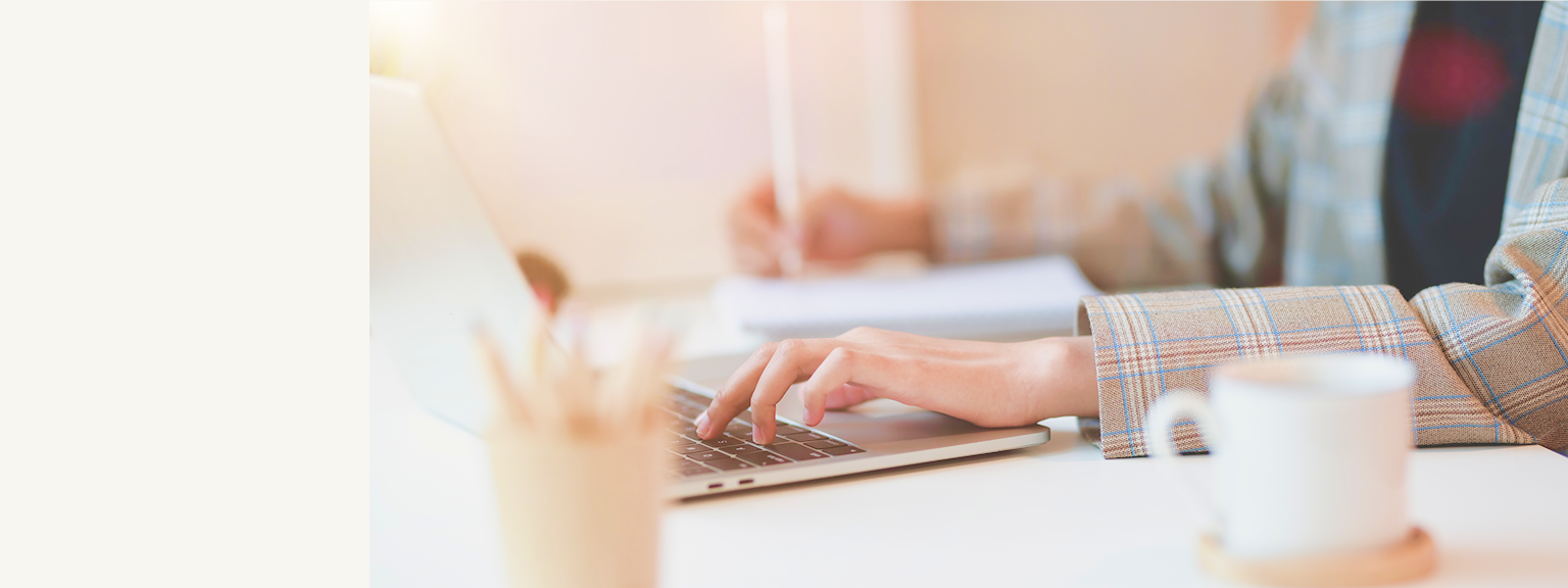 Hands typing on a laptop.