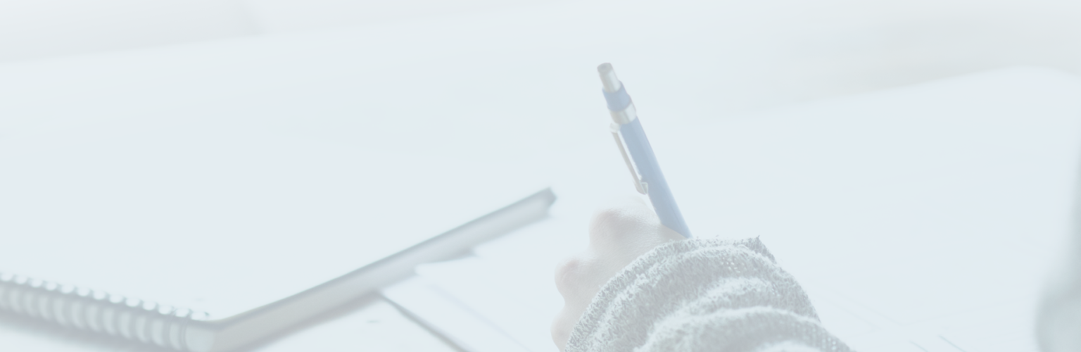 A close-up shot of an individual writing in a journal.