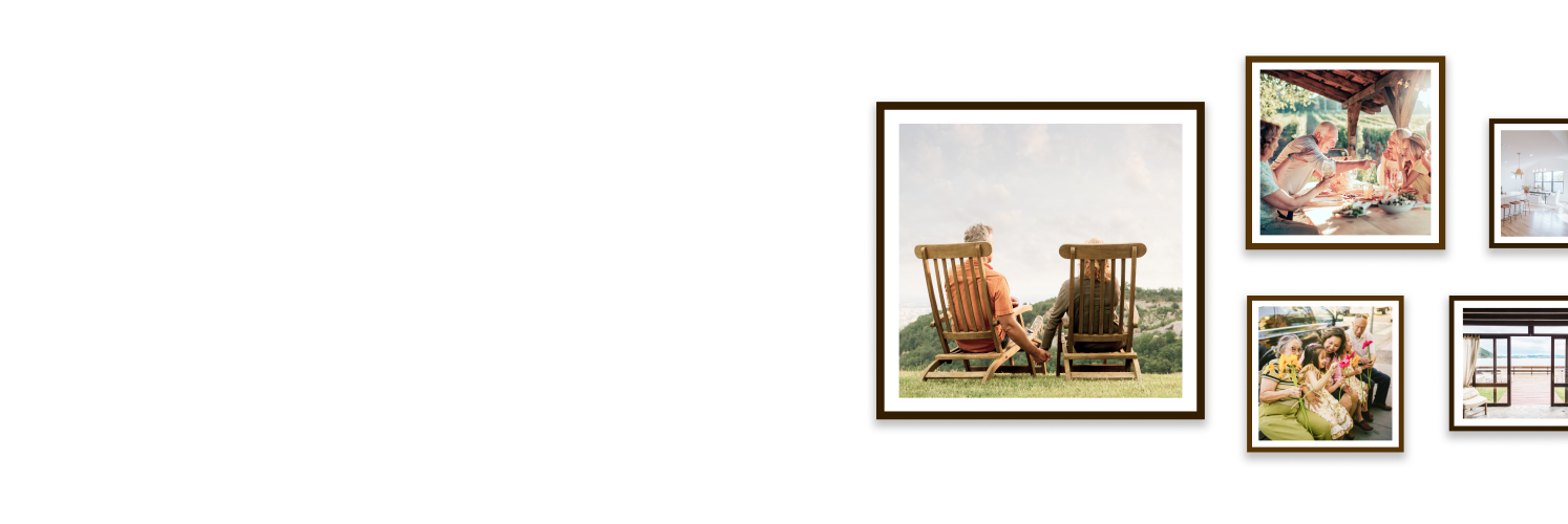 A gallery wall featuring framed photos of a couple holding hands while taking in a mountain view, a multigenerational family enjoying a meal outside together, and another family posing with flowers.