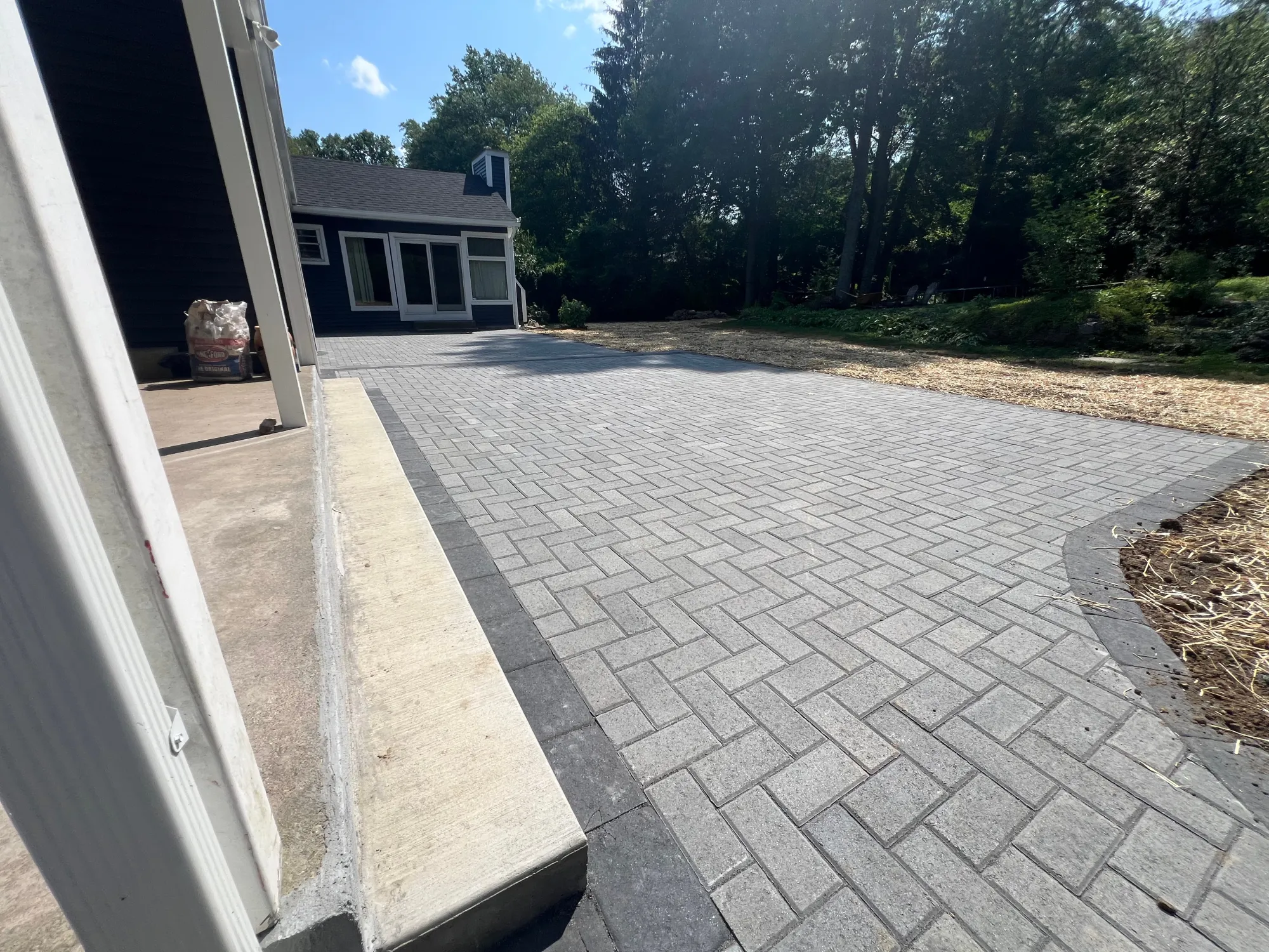 Paver patio with sitting wall - Patios project by General Masonry LLC.
