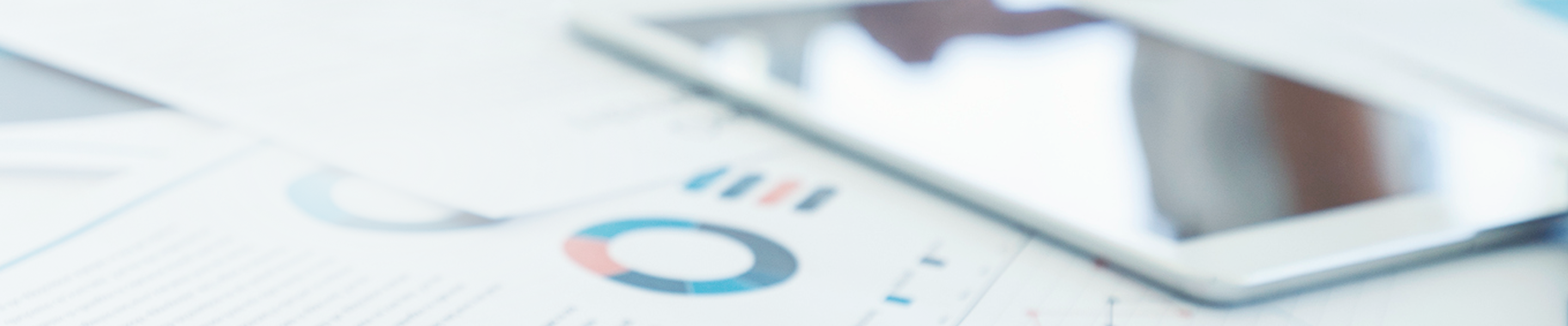 Documents and tablet laid out on a table.