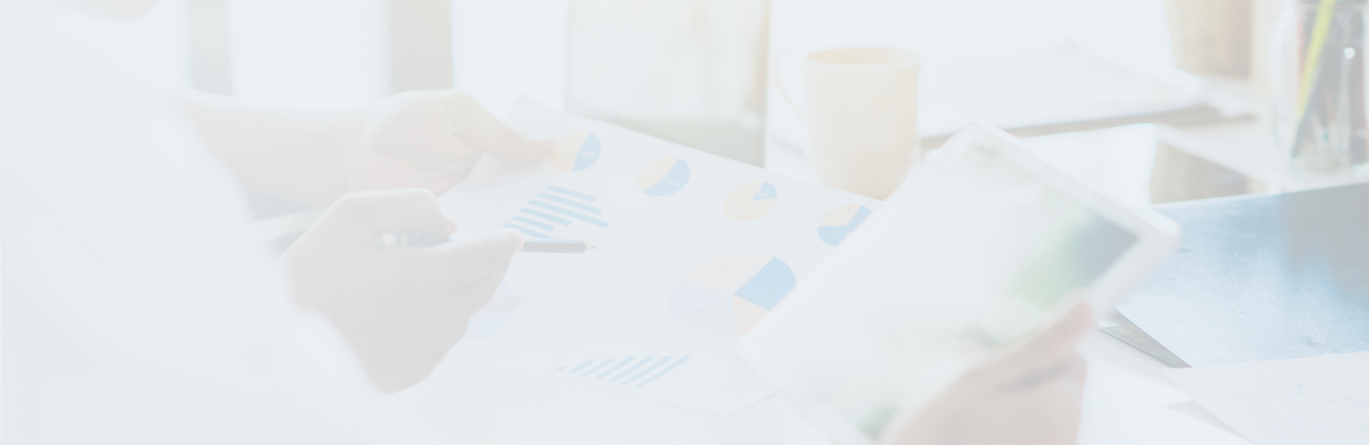 Close-up of two people reviewing charts and graphs.