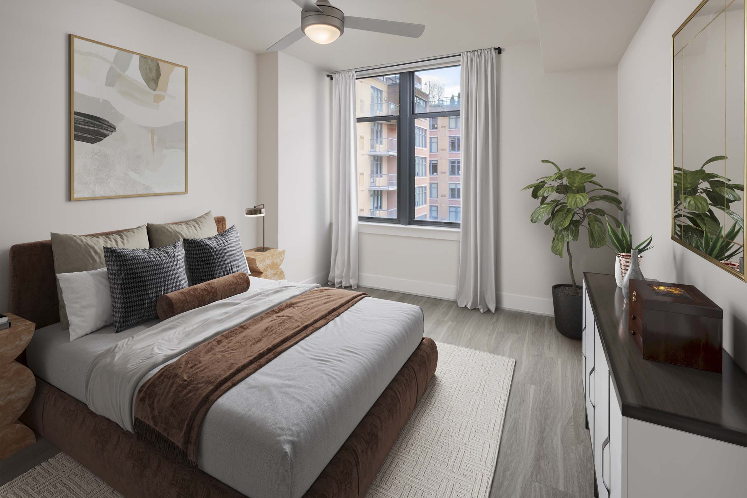 Contemporary style bedroom with lighted ceiling fan and large windows for natural light at Camden NoMa Apartments in Washington, DC.