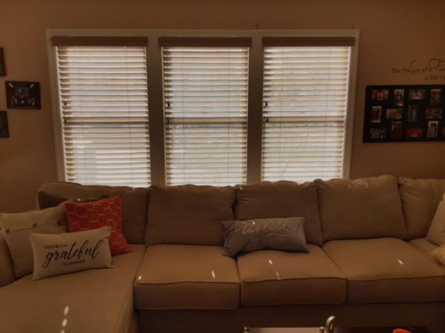 Wood Blinds installed by Budget Blinds of Ossining made a stylish improvement in overall look and function and warmed up this living room drastically! #BudgetBlindsOssining #BlindedByBeauty #WoodBlinds #FreeConsultation #OssiningLivingRoomWoodBlinds
