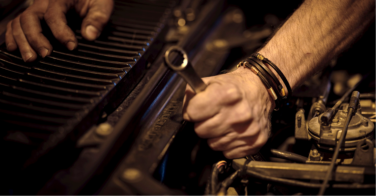 Close-up of mechanic performing vehicle repair with hand tools. Skilled workmanship and detailed component adjustments help maintain performance, reliability, and safe operation across automotive systems.