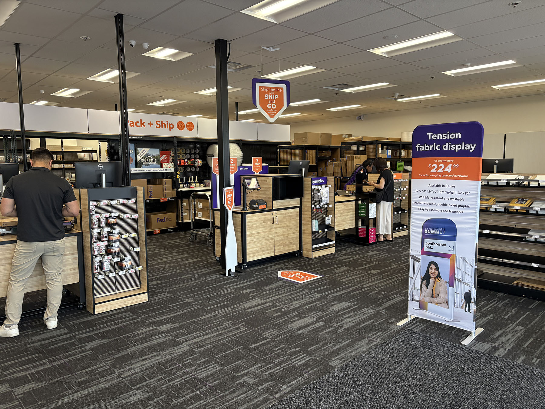 Interior Overview and Service Area &ndash; Wide view of FedEx Office Beaverton showing print stations, packing area, retail supplies, and customer service counters.