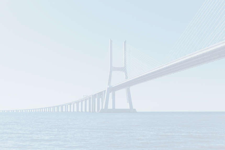 Long cable-stayed suspension bridge spanning across calm blue water under clear sky.