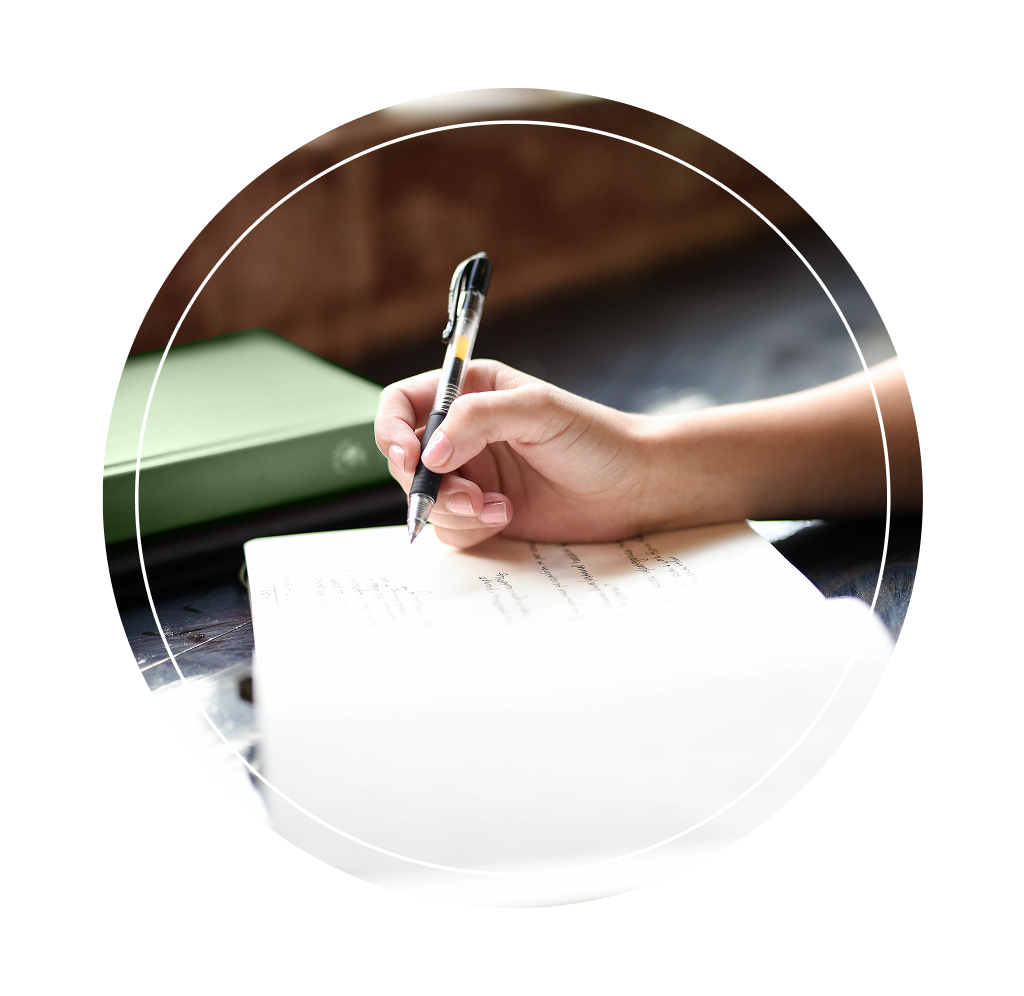 An individual writing in a journal.