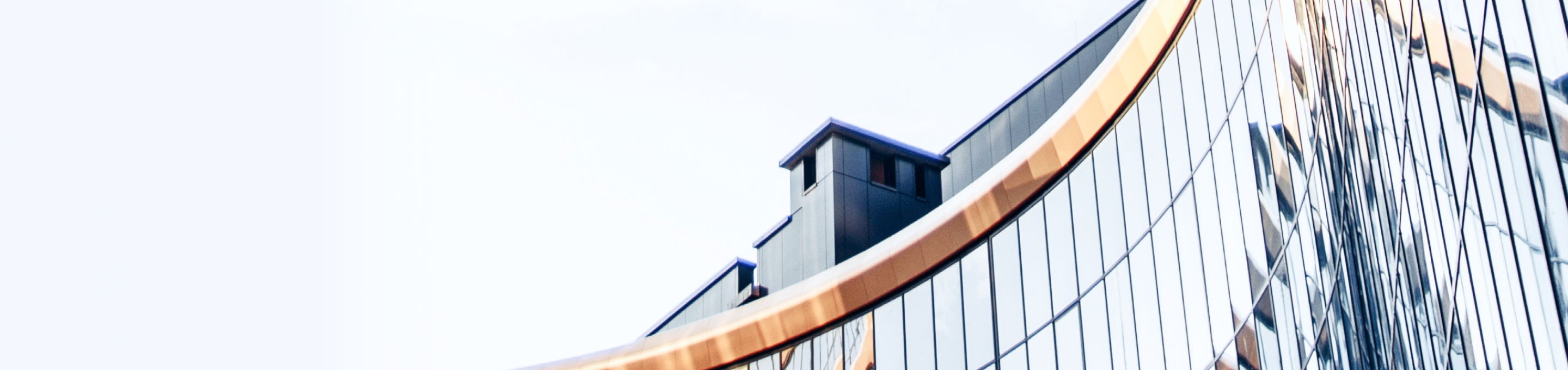 Close-up architecture shot of a building with a curved glass façade.