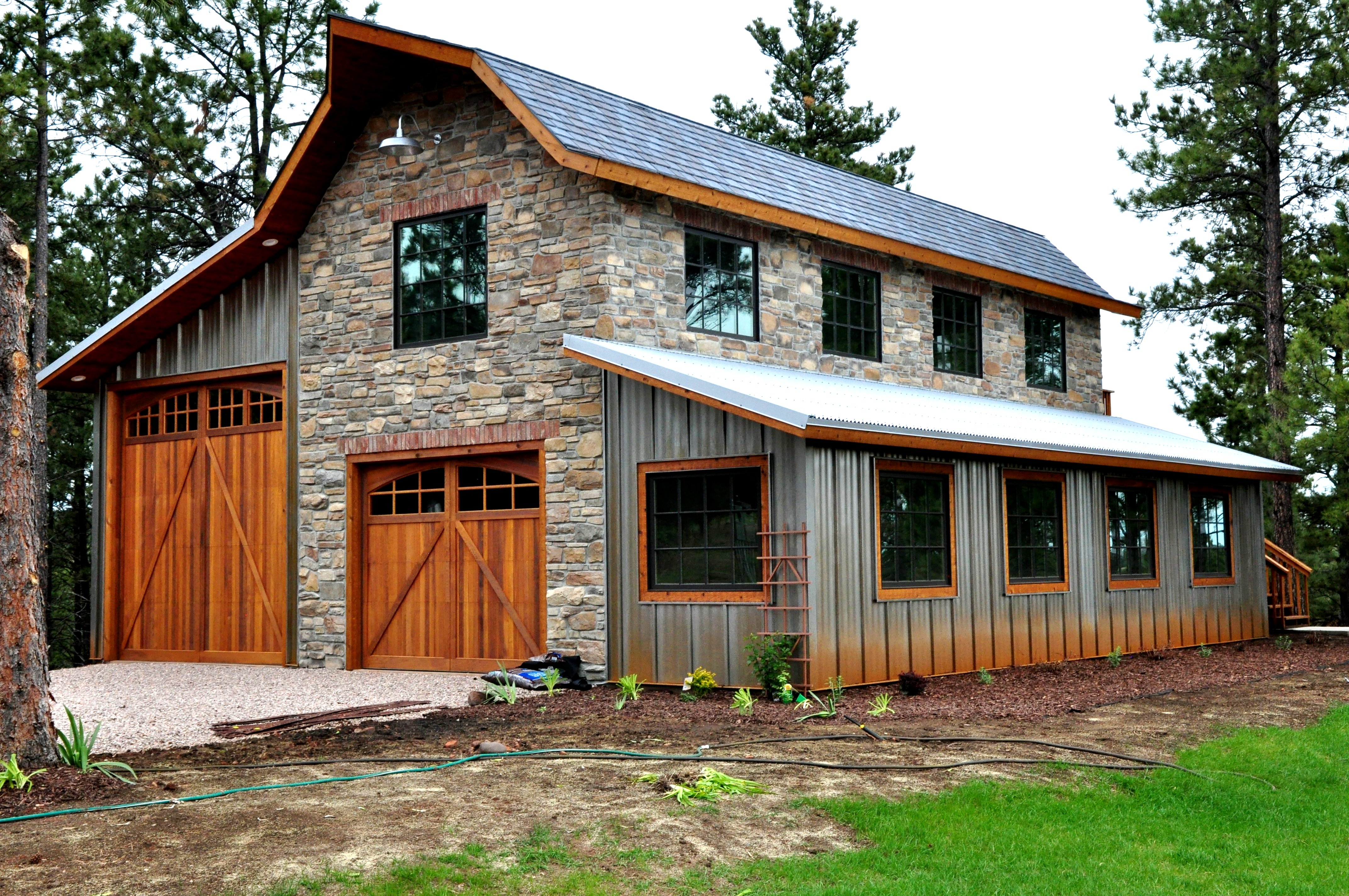 Custom garage and workshop built with metal siding and roofing materials, combining strength, low maintenance, and rustic design appeal.