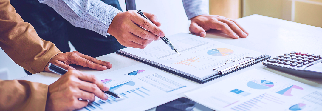 An individual looking at charts on a clipboard.