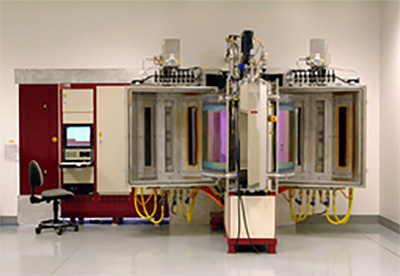 DSI's proprietary MicroDyn® magnetron sputtering deposition system featuring dual octagonal chambers for high-volume precision coating production. This advanced PVD system incorporates secondary-activation plasma source using microwaves for complete oxidation control and produces exceptionally dense, hard coatings with superior environmental stability compared to conventional evaporation methods. Capacity up to 30 square feet per batch.