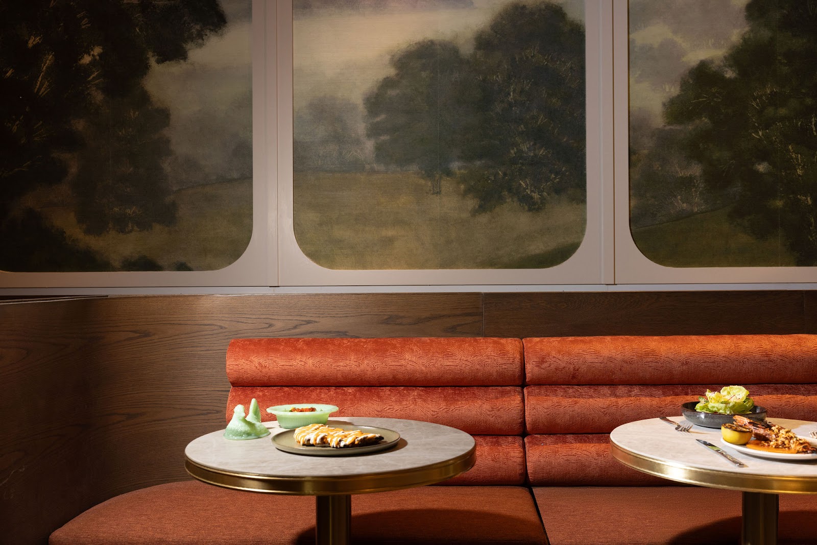 Burnt orange banquette seating in the Markette dining room. Part of the Fogarty Finger designed space in Chelsea, Manhattan.