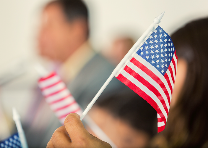 People waving small, handheld American flags.