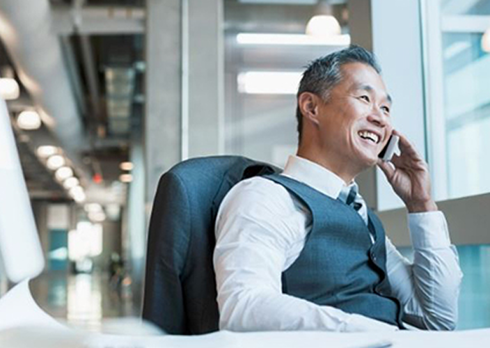 A business owner on the phone at his office.