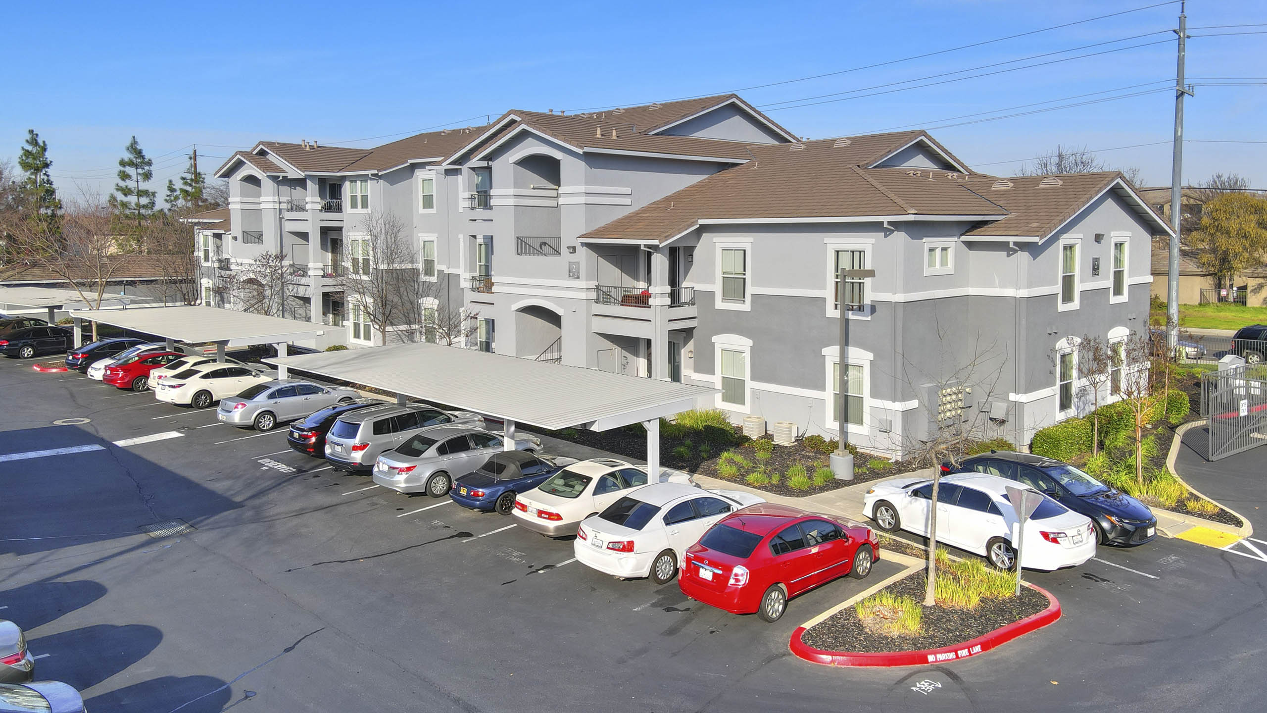 Covered carports with multiple parking spaces and apartment buildings