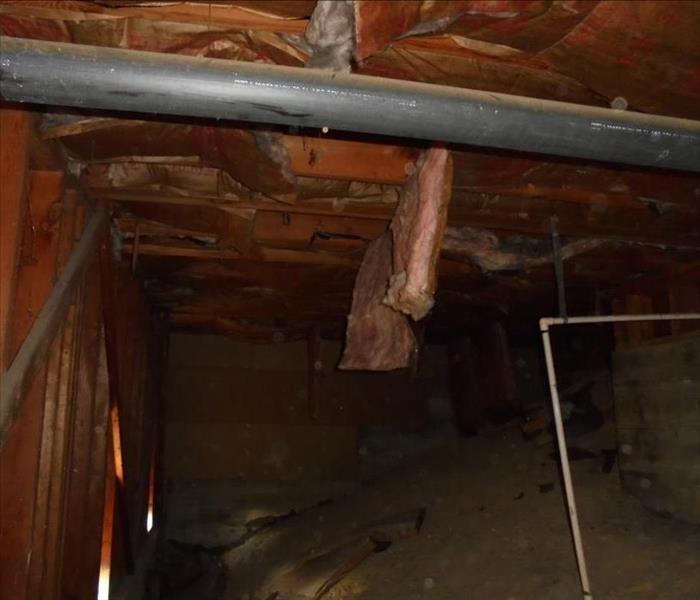 A clean water pipe burst underneath this Silver Lake condo. It cause the insulation to start to fall off the wood due to being so saturated in water. SERVPRO was called to dry out the crawlspace and remove all the wet materials. The owner was pleased that we were able to dry out the home and prevent any mold growth in her condo.